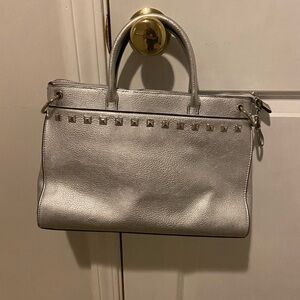 Carlos Santana Silver faux leather shoulder bag with Silver studs.